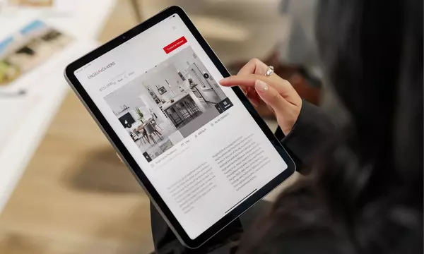 Tablet in realtor's hand showing Engel & Volkers online platform