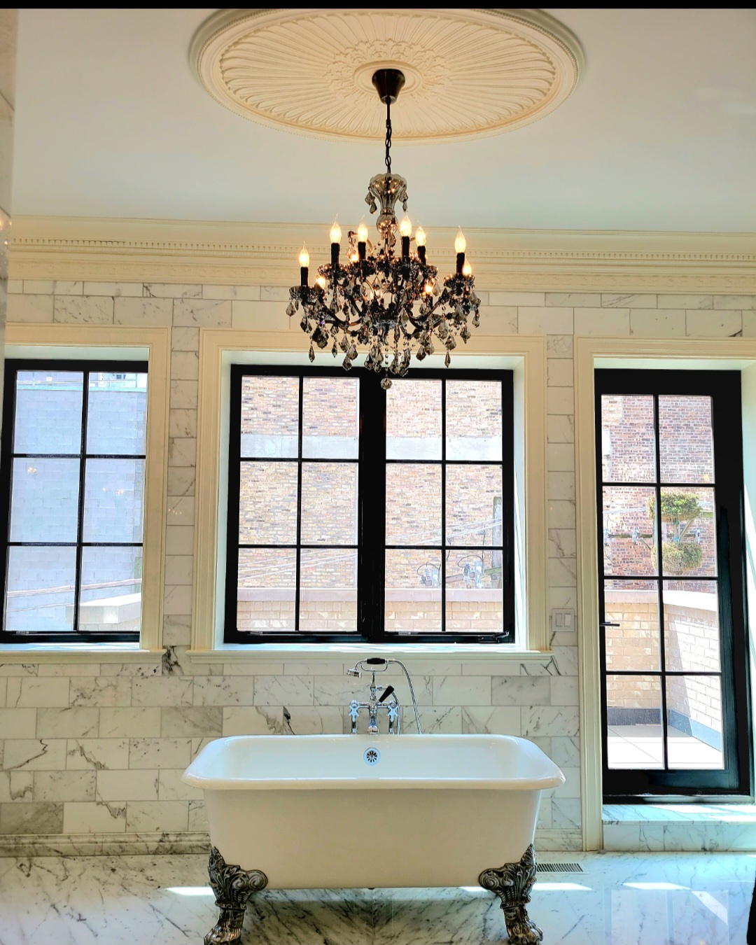 Bespoke Chandeliers over custom marble tub in bathroom