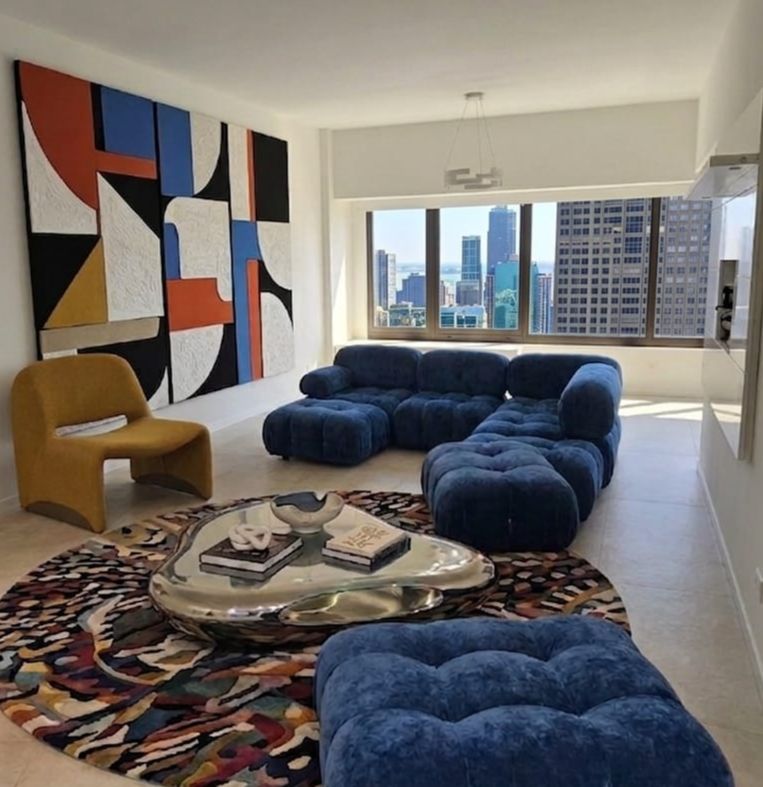 Living room with panoramic Lake Michigan and Navy Pier views from Hancock Tower Unit 4723 Chicago