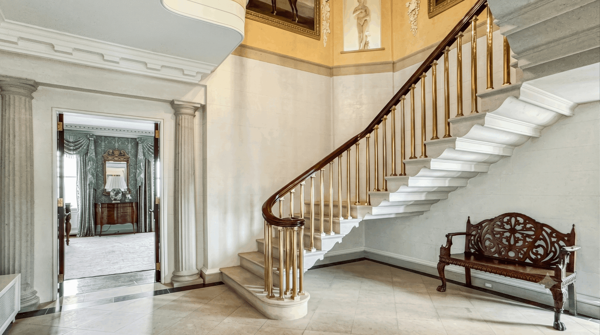 Bespoke craftsmanship and structural permanence: The grand two-story limestone staircase at 1530 N. State Parkway, Duplex 12-13 ($5,995,000).