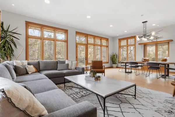 midcentury modern living room with large windows and modern lighting