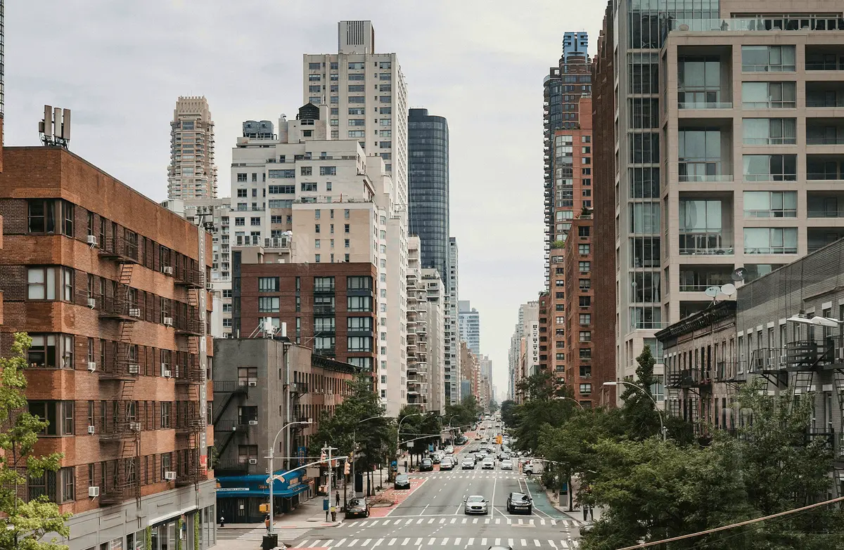 Busy urban street lined with mid-rise and high-rise residential buildings, reflecting Houston area housing market blog topics