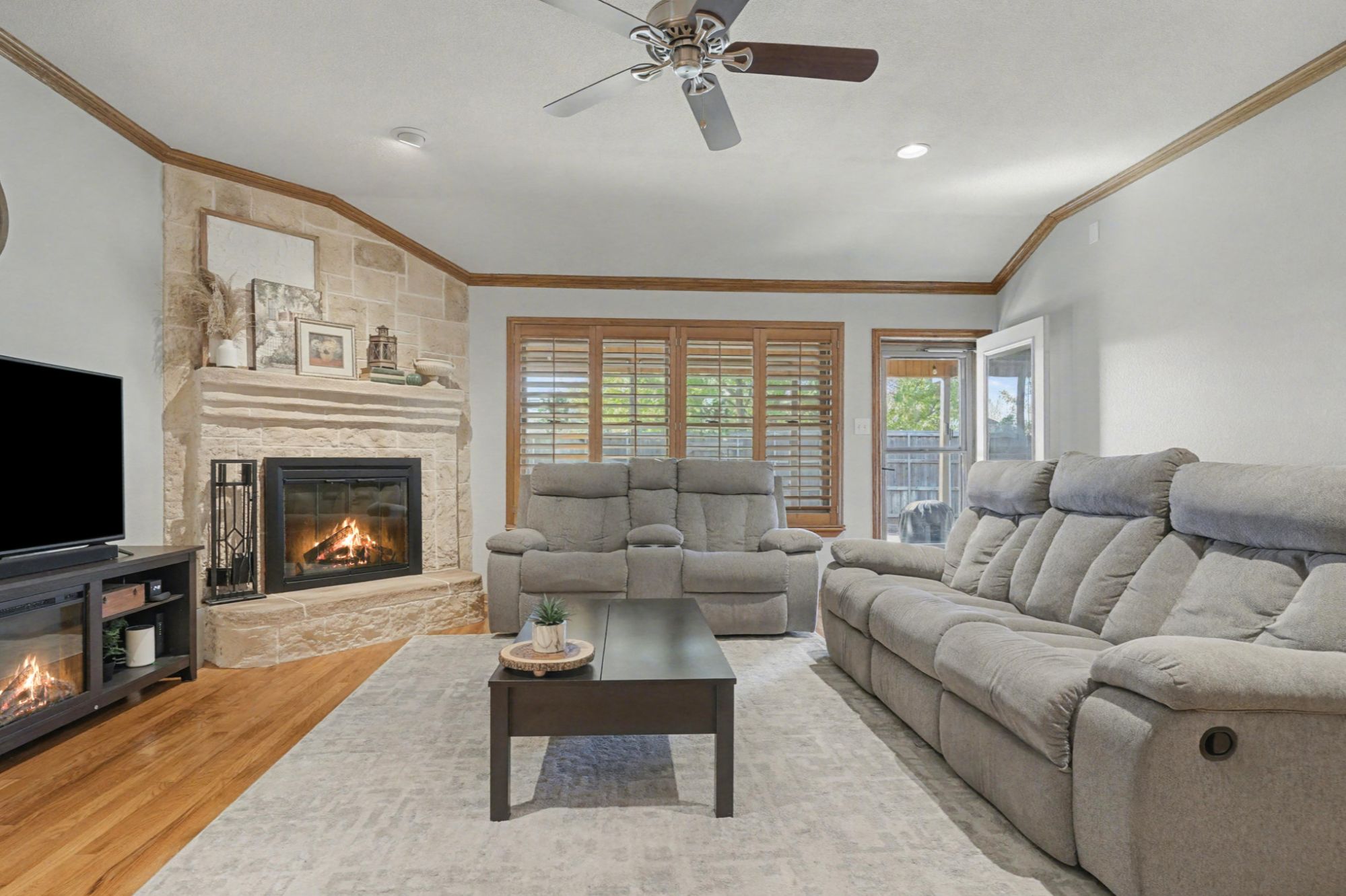 Family Room with Hardwood Floors and a Stone Wood Burning Fireplace
