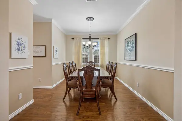 Formal dining room with updated flooring and crown molding