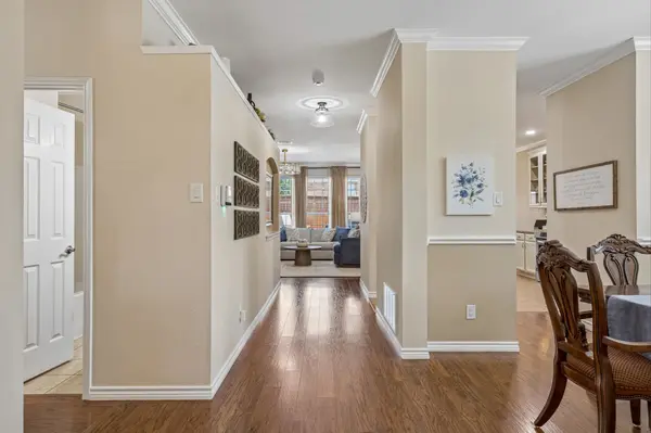 Extended entry hall with architectural columns and crown molding