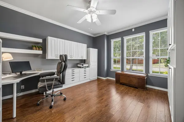 Spacious home office with custom storage and updated flooring