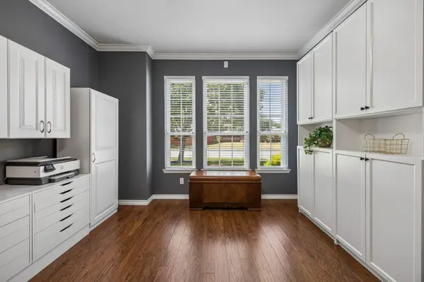 Home office with extensive built-in workspace and natural light