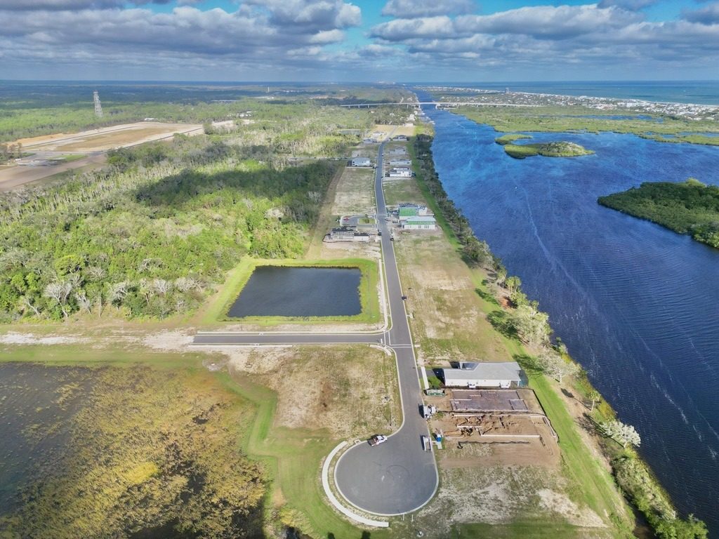 Homes going up alongside finished residences. This is what the early phase looks like today, with the Intracoastal and the bridge in the distance.