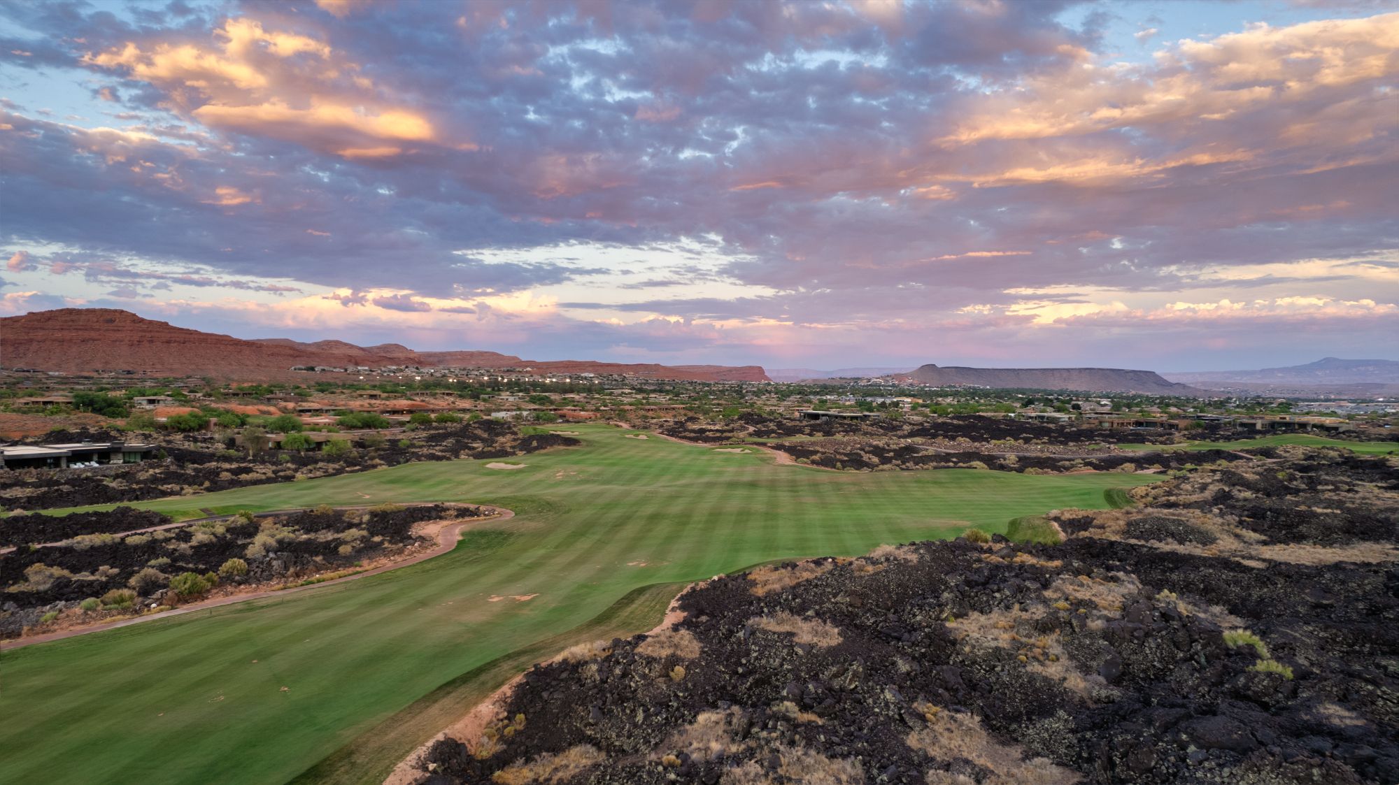 Entrada at Snow Canyon golf course community in St George Utah with lava‑rock fairways, red‑rock cliffs, and luxury homes