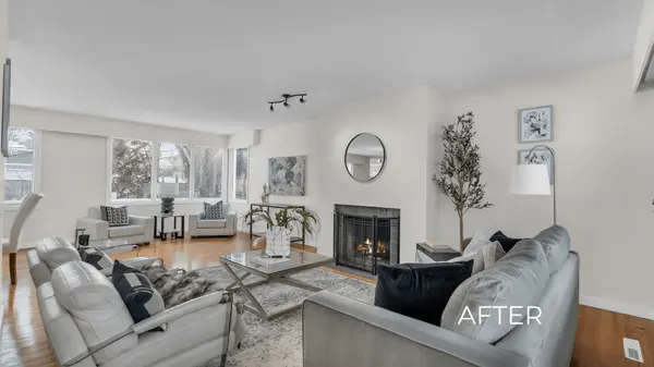Living room in a Saskatoon home after professional updates, freshly painted and staged with modern furniture, bright décor, and a welcoming fireplace