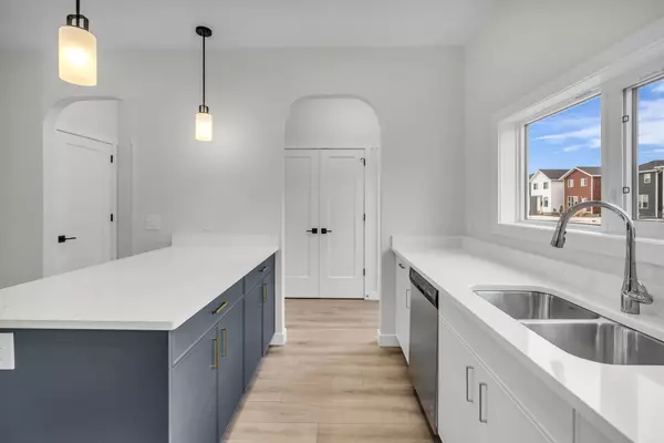Open-concept main floor with bright living space, large kitchen island, and modern finishes.