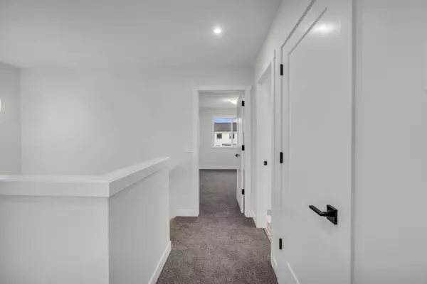 Open-concept main floor with bright living space, large kitchen island, and modern finishes.