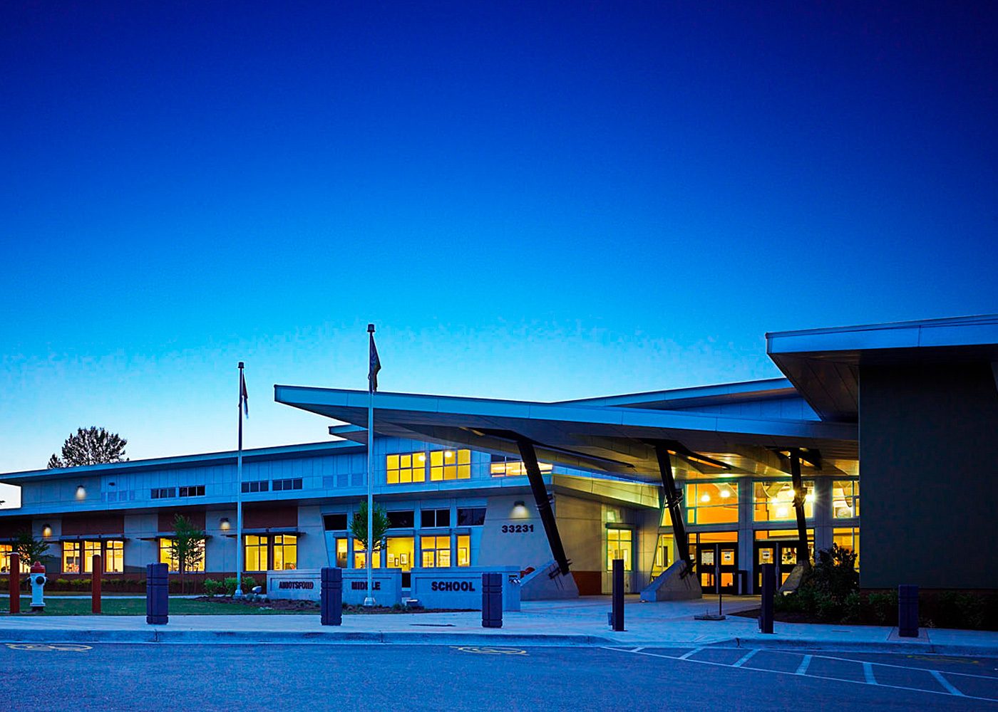 Abbotsford Middle School illuminated at dusk with dramatic roofline