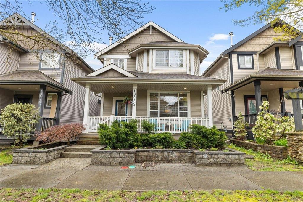 Detached home with a covered front porch on a residential street in Clayton, Surrey