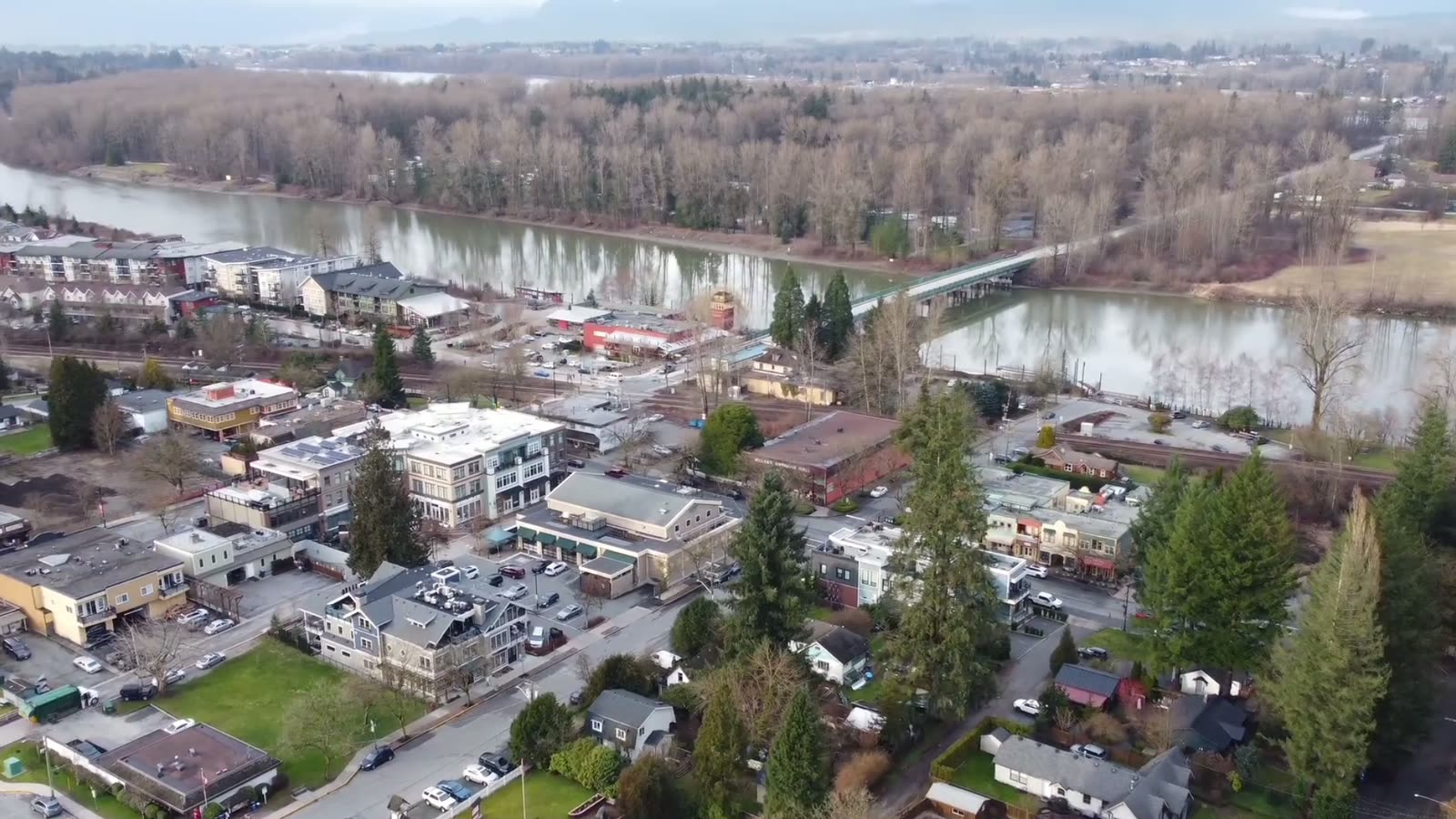 Aerial view of Fort Langley village in Langley, BC, looking over the Glover Road shops toward the bridge to McMillan Island and the Bedford Channel of the Fraser River