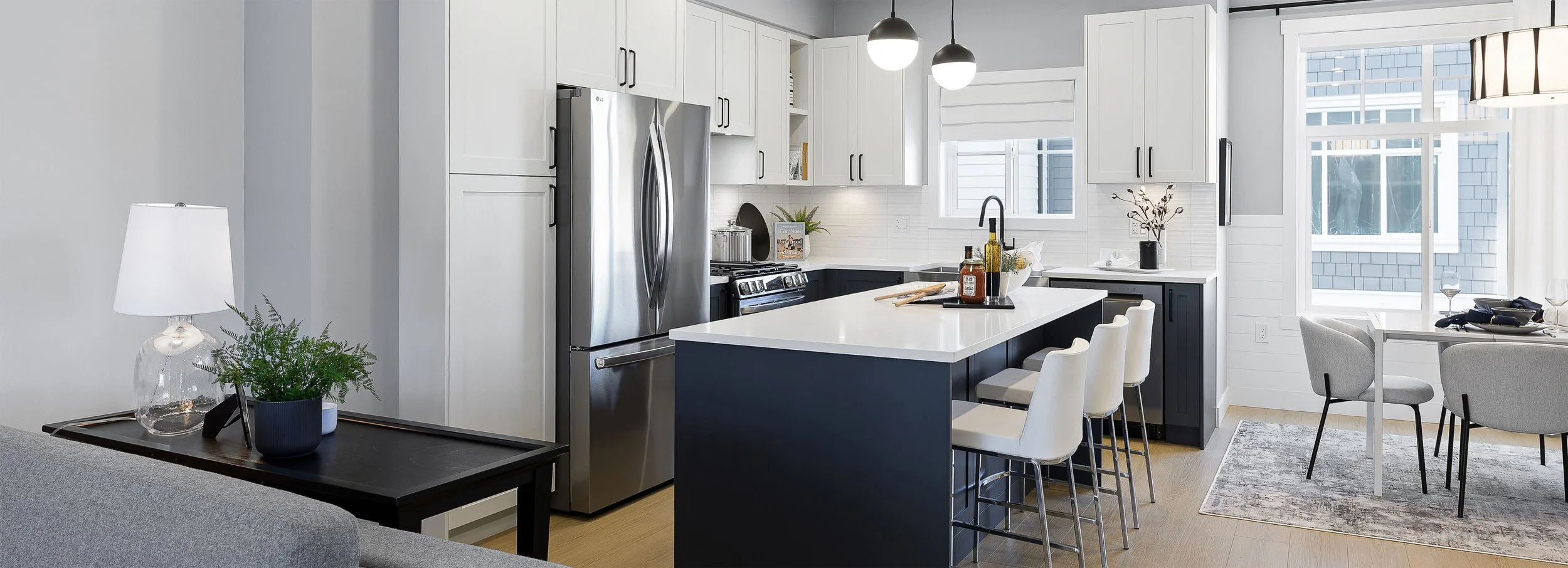 Griffon Langley townhome kitchen interior render: white shaker cabinetry, quartz waterfall island, stainless French-door fridge, pendant lighting