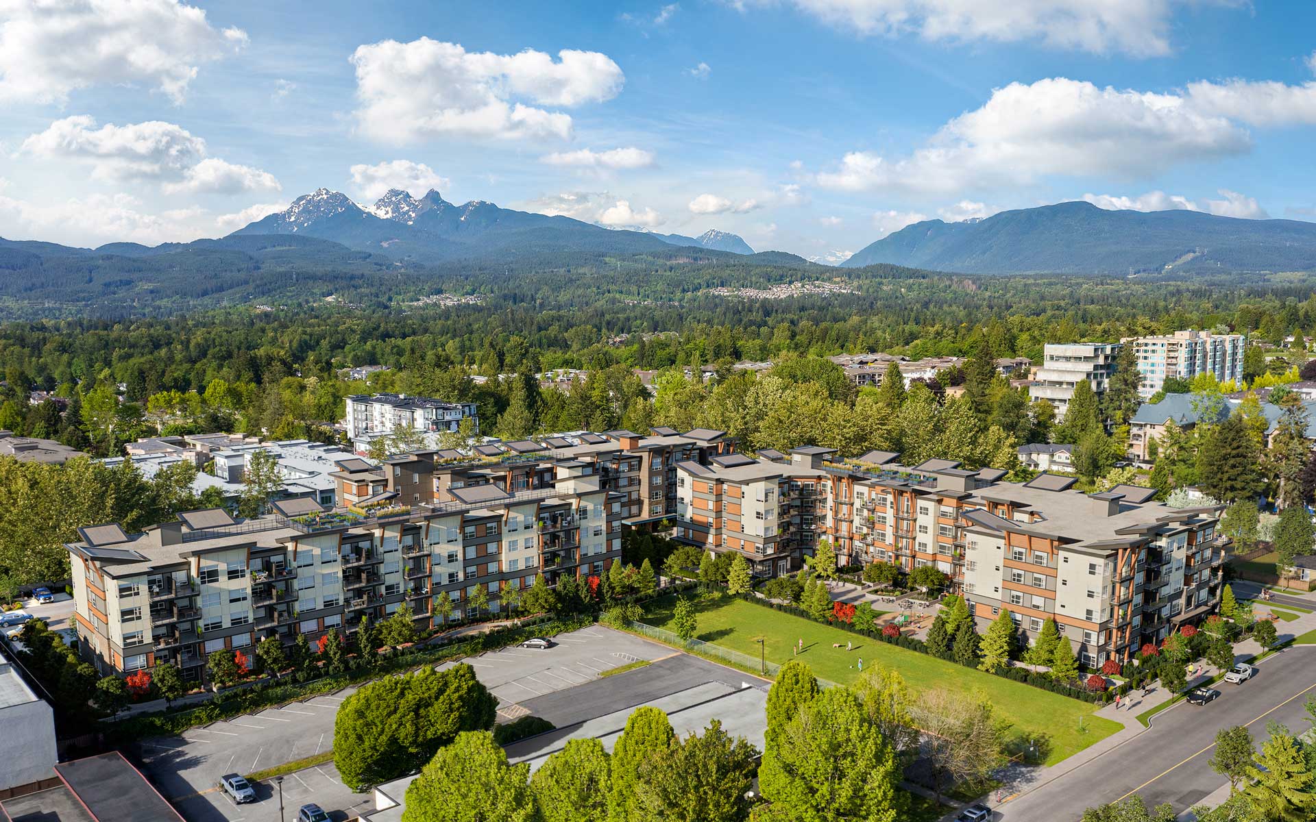 Aerial view of Inspire Maple Ridge showing low-rise condo buildings in Town Centre framed by Golden Ears and North Shore mountains