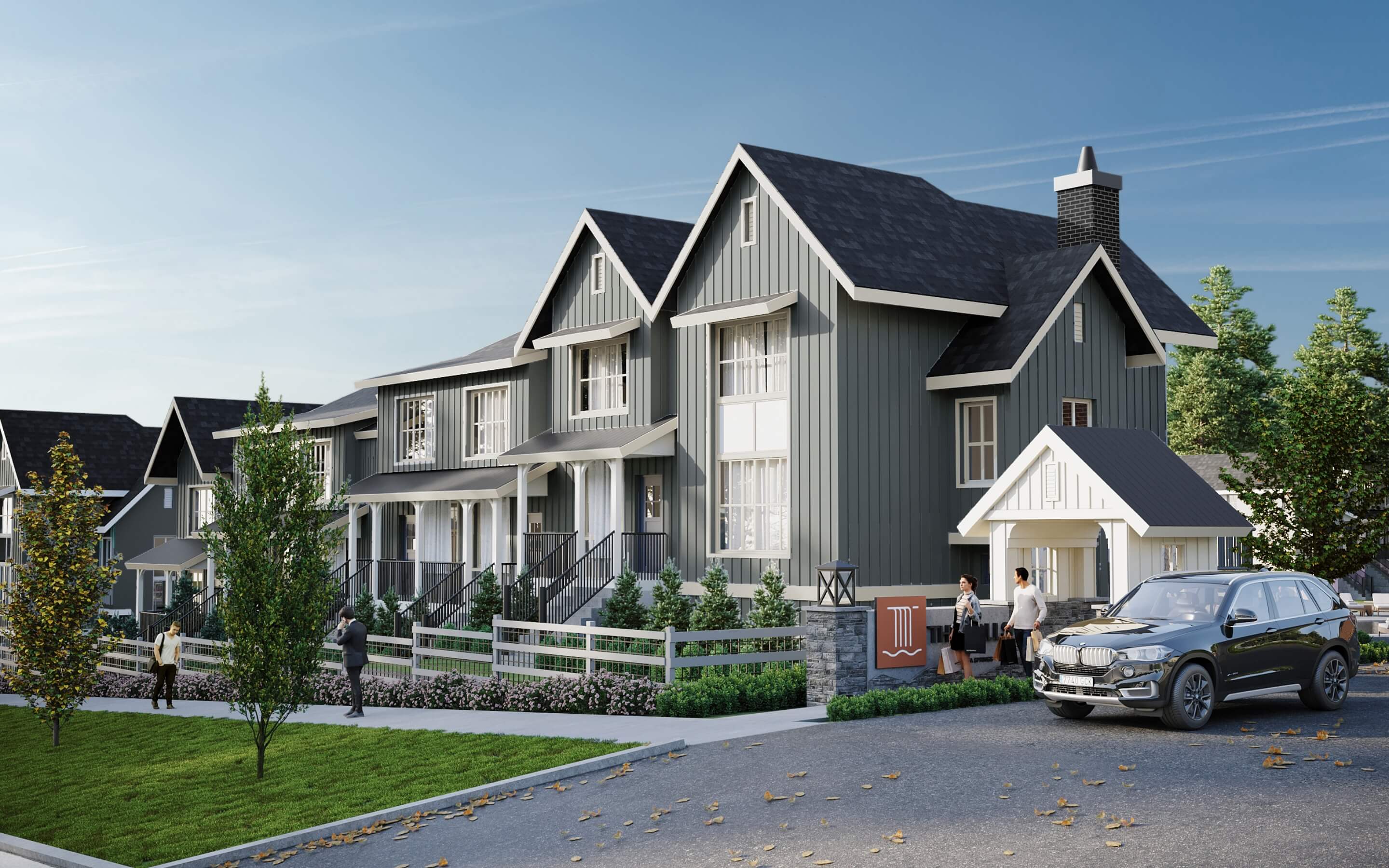 The Falls at Kanaka Springs end-unit townhome render with grey board-and-batten siding, gabled roof, stone-accent entry, and front porches in East Maple Ridge