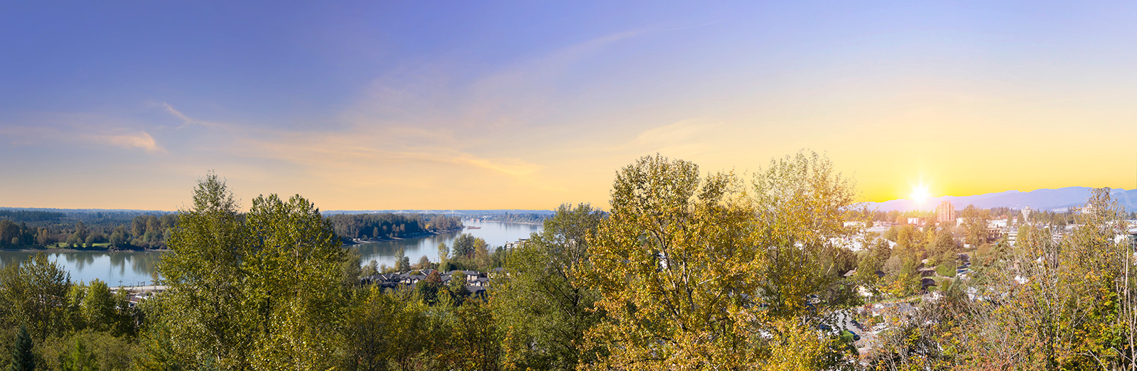Fraser River panorama at sunset with Maple Ridge skyline framed by autumn trees, the kind of view Highpointe buyers get from upper-floor homes