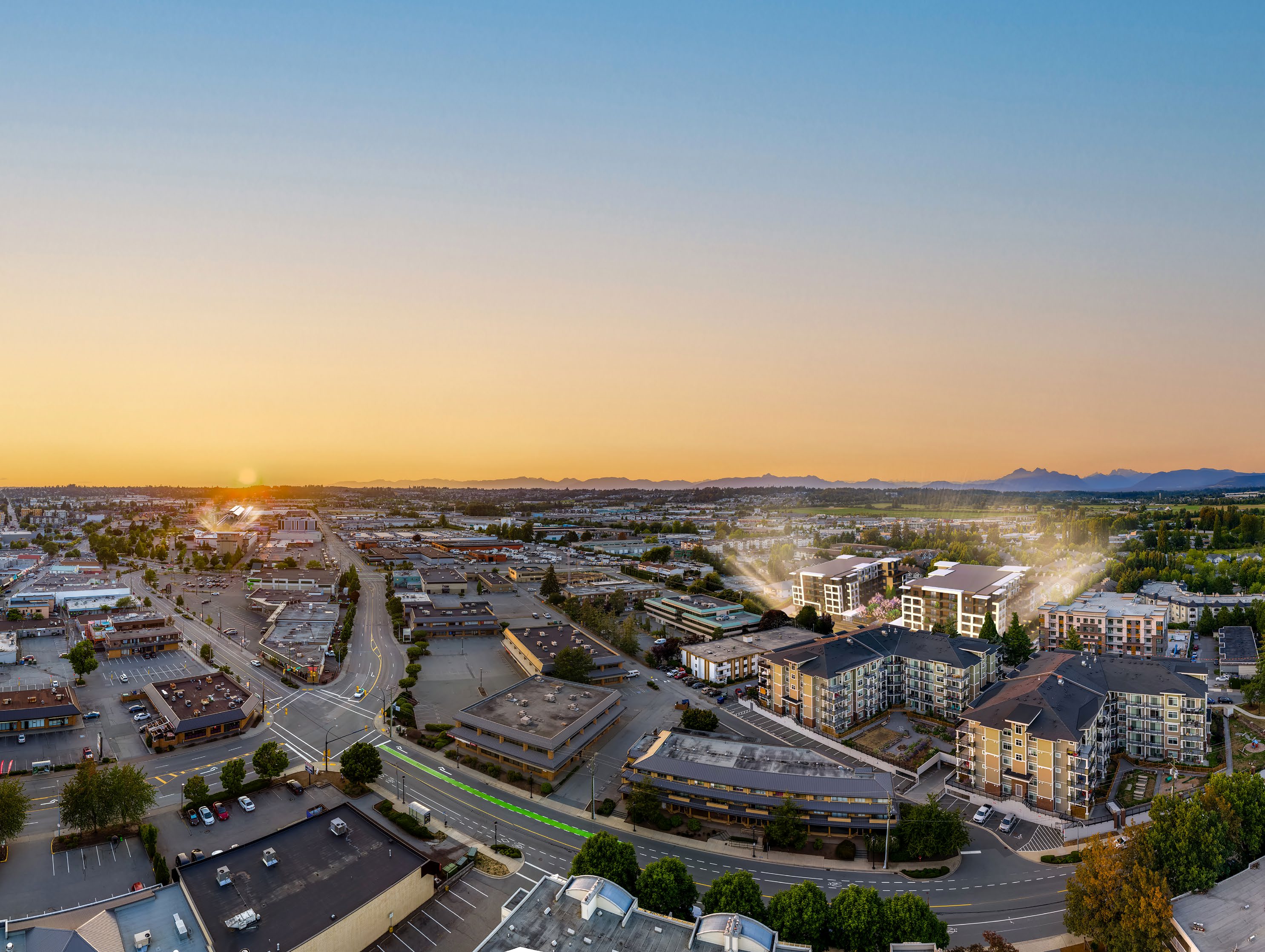 Kamilia condos aerial view of the building in Downtown Langley City with Fraser Valley mountain backdrop