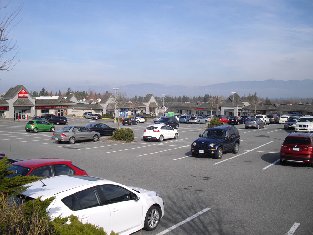 Walnut Grove neighbourhood shopping plaza with the North Shore mountains in the distance