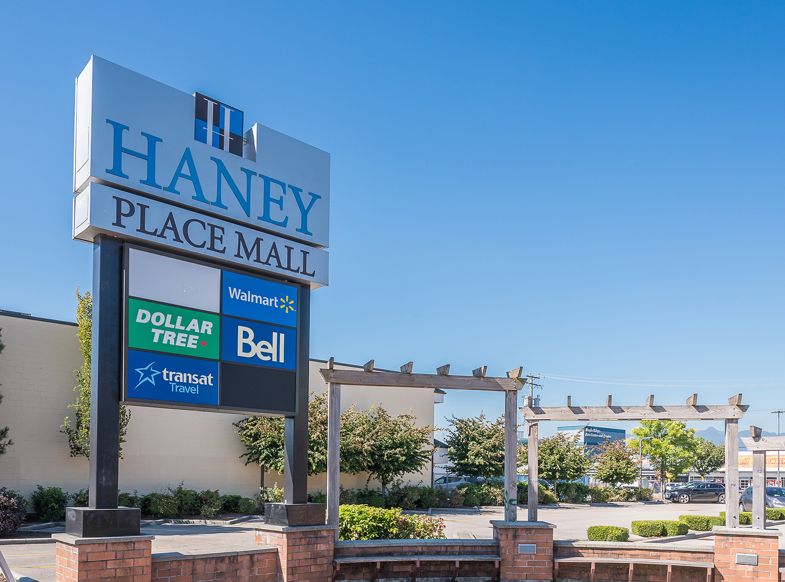 Haney Place Mall sign with Walmart, Bell, Dollar Tree, transat Travel tenants