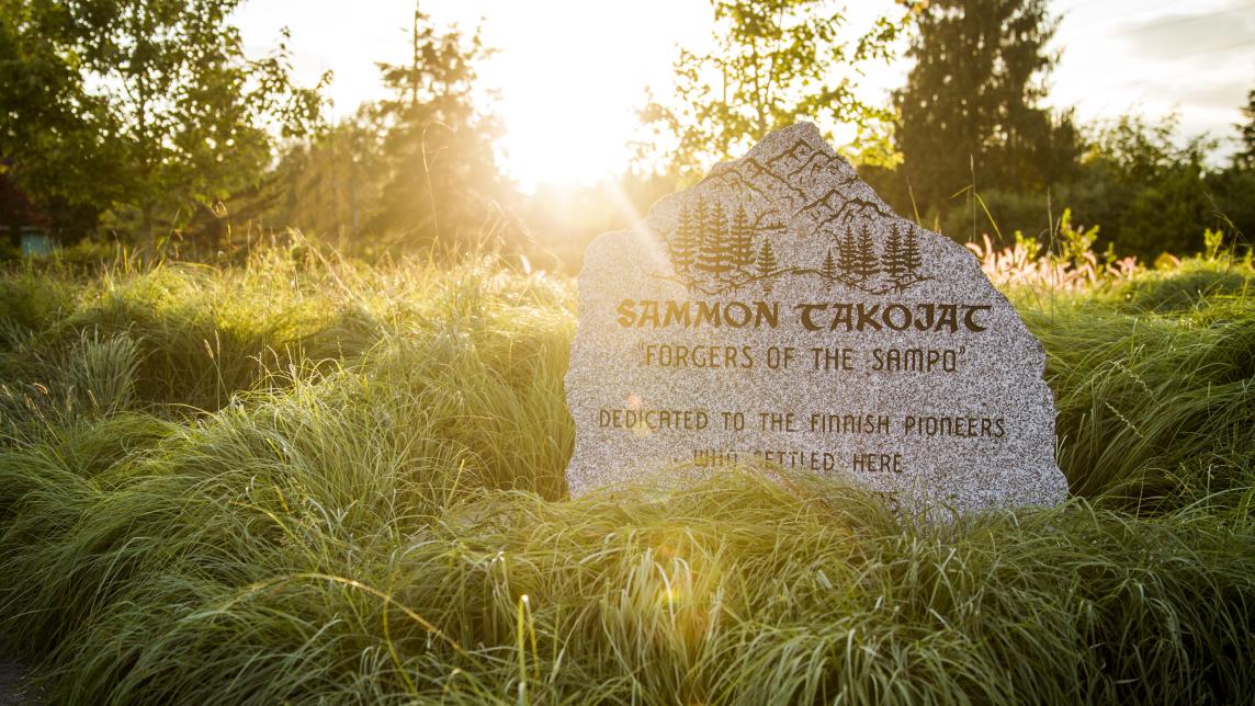 Sammon Takojat Finnish pioneer memorial stone in Websters Corner Park at golden hour