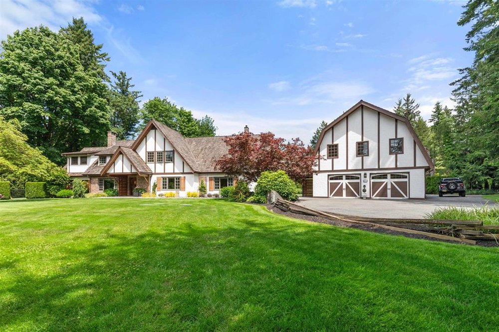 Langley Tudor-style home with carriage house