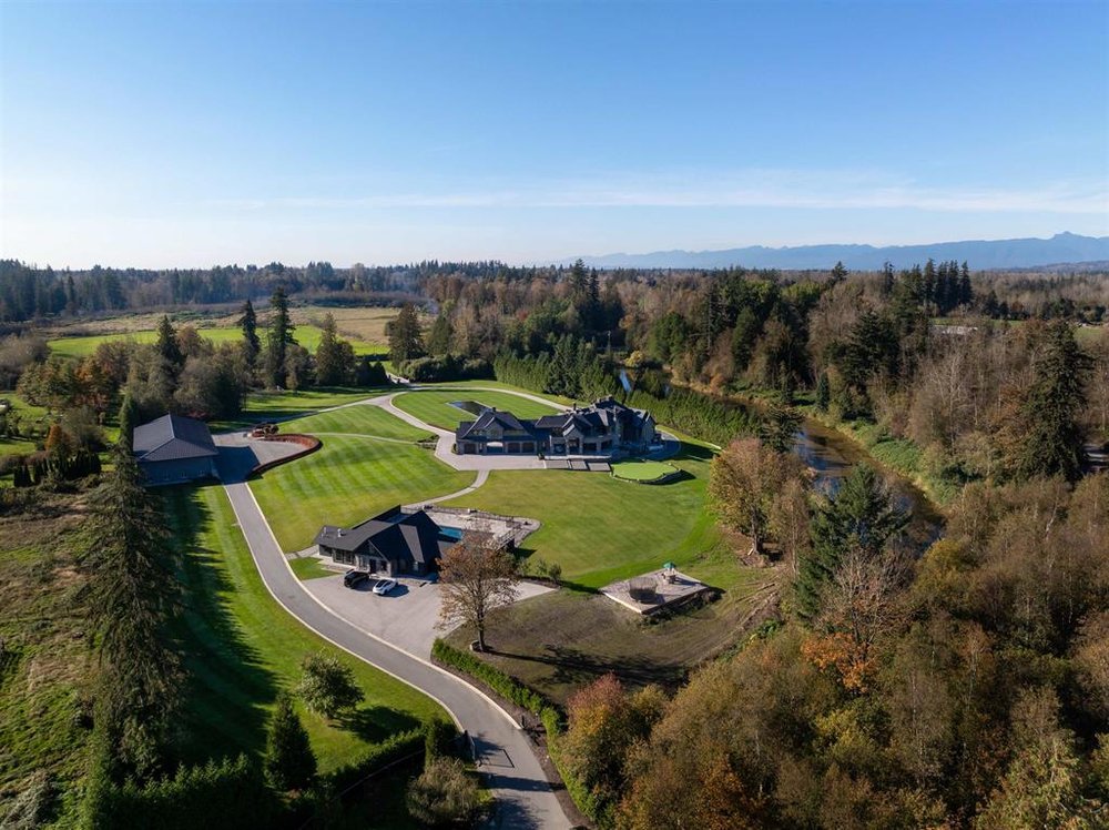 Aerial view of Glen Valley, Langley BC, with farms, vineyards & the Coast Mountains