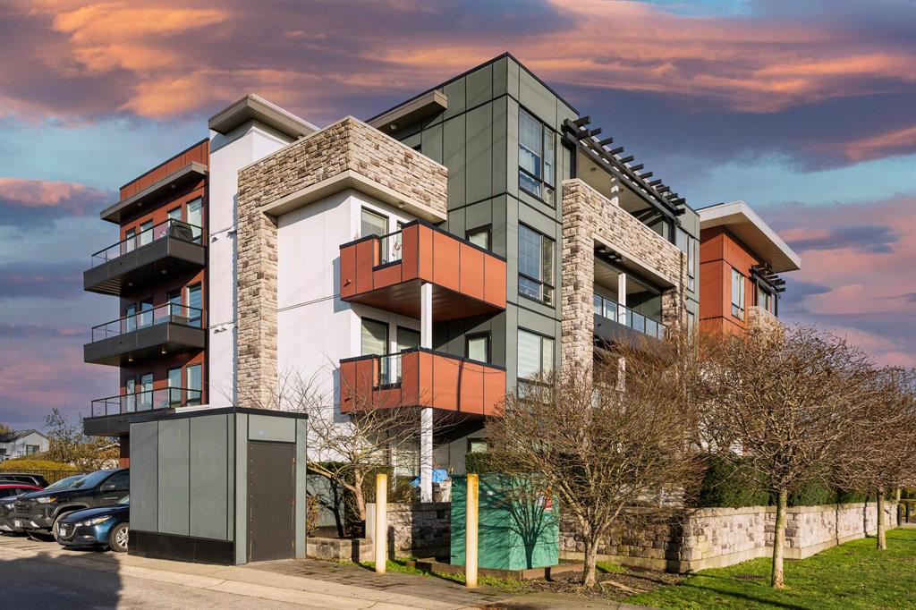 A low-rise strata condo building in Maple Ridge with balconies and surface parking at street level