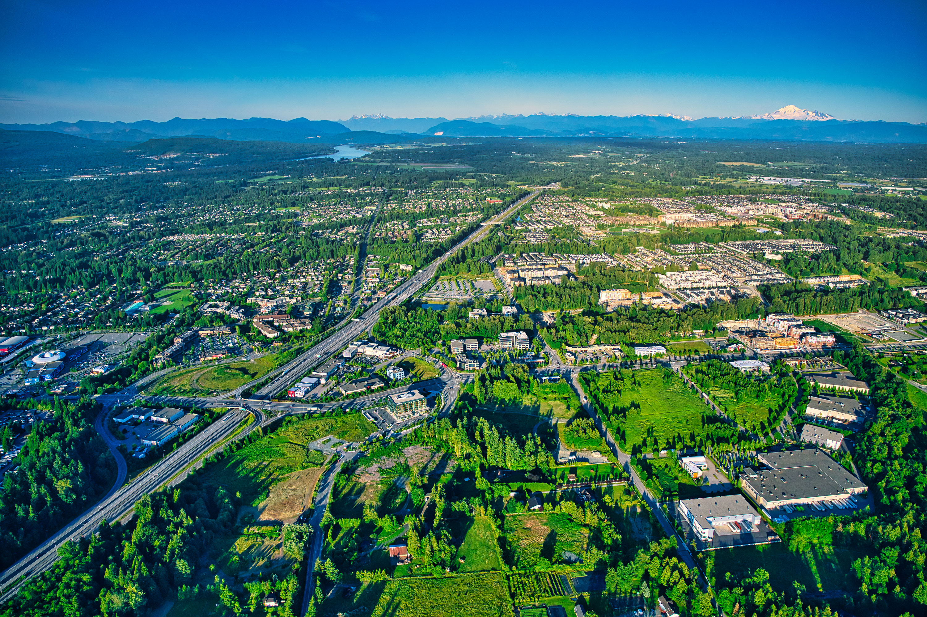 Aerial drone view of Langley Township with the Fraser Valley and Coast Mountains beyond