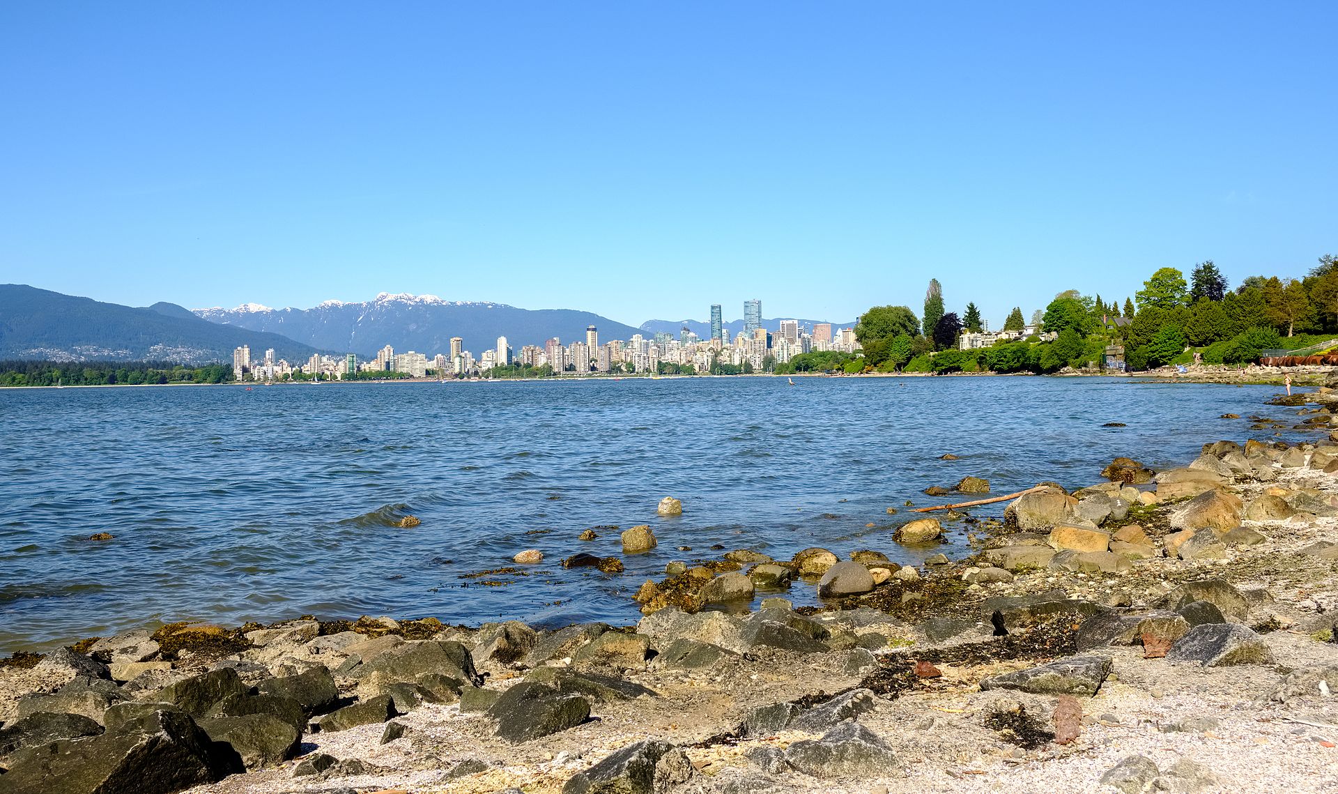 Vancouver downtown skyline and North Shore mountains seen across English Bay