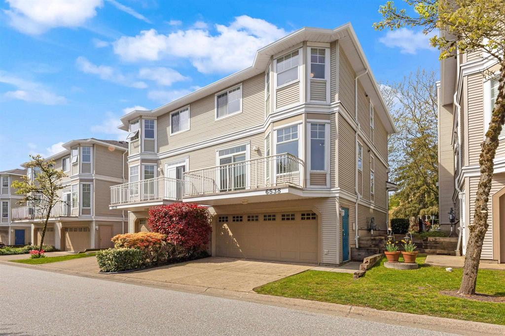 A townhouse complex with double garages on a quiet lane in West Newton