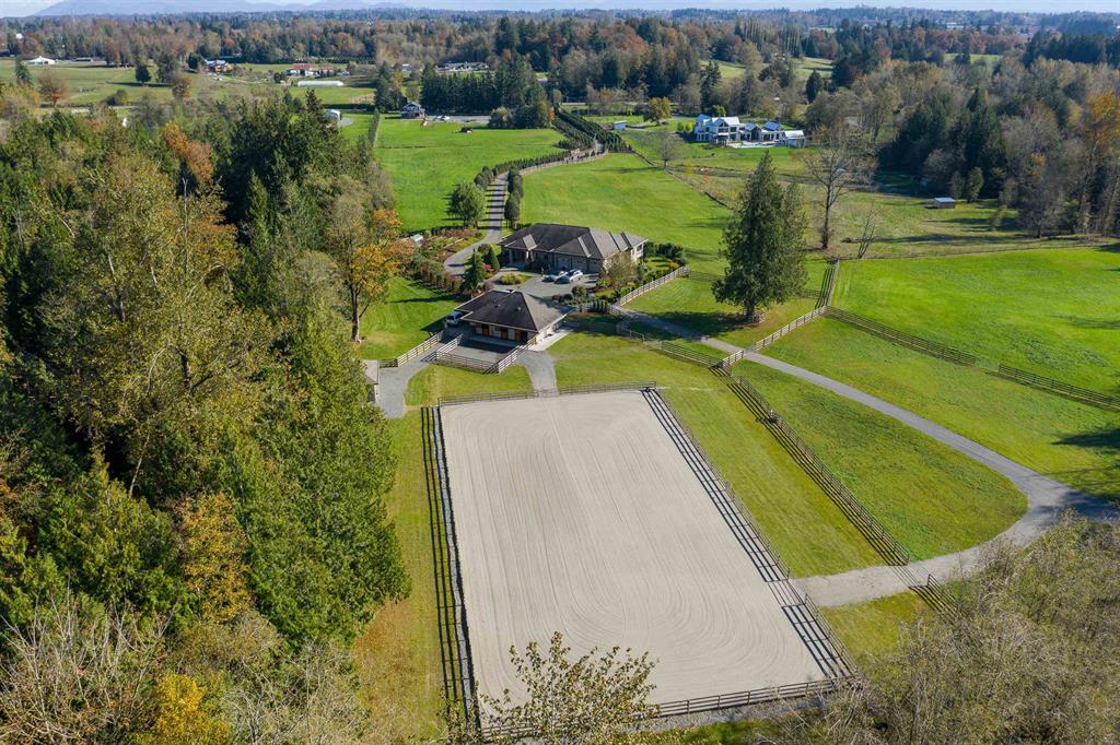 Aerial view of a horse property with a riding arena in South Langley