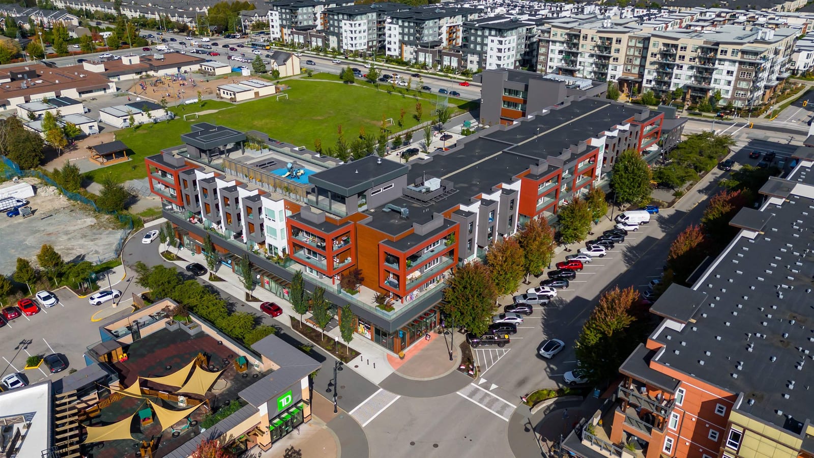 Aerial view of mid-rise condos at a Willoughby town centre corner in Langley