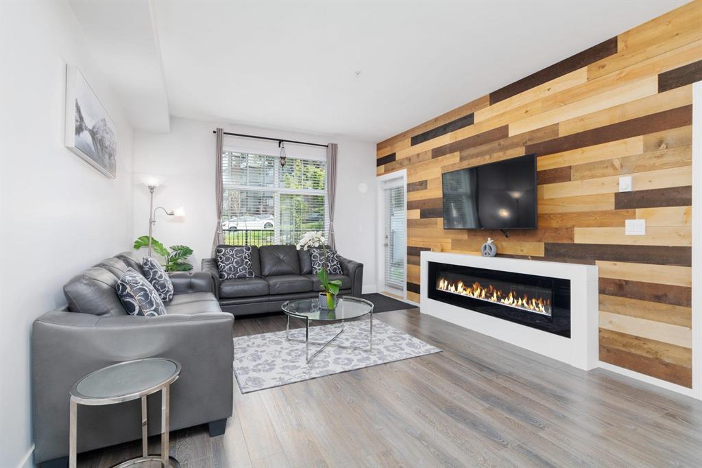 Living room with a linear fireplace in a Crescendo condo