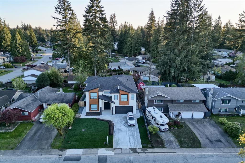 Aerial view of a new infill home among older houses in Langley City