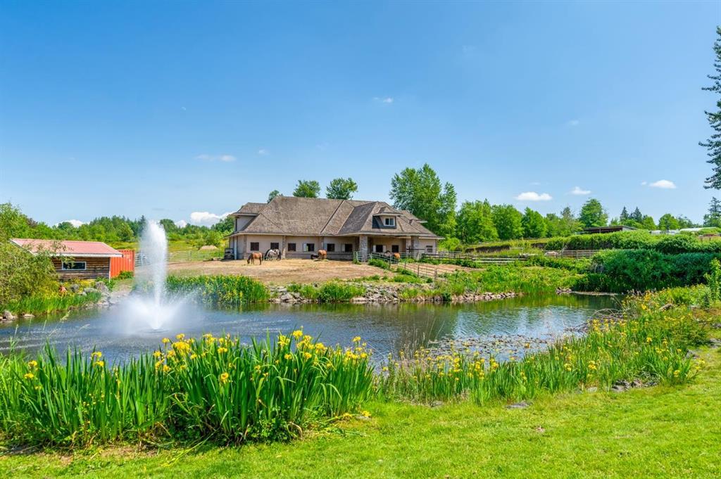 Rural property with a pond and fountain in the Otter District of Langley