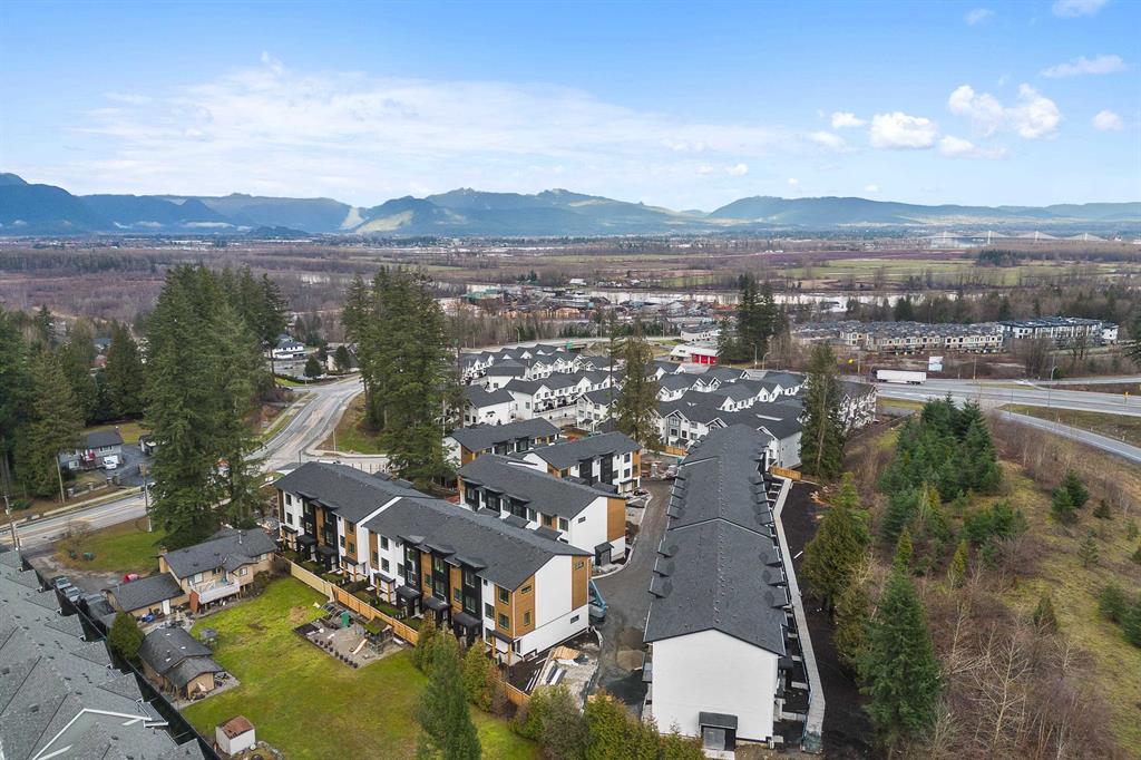 Aerial view of a townhome complex in Fraser Heights, Surrey, with the mountains beyond