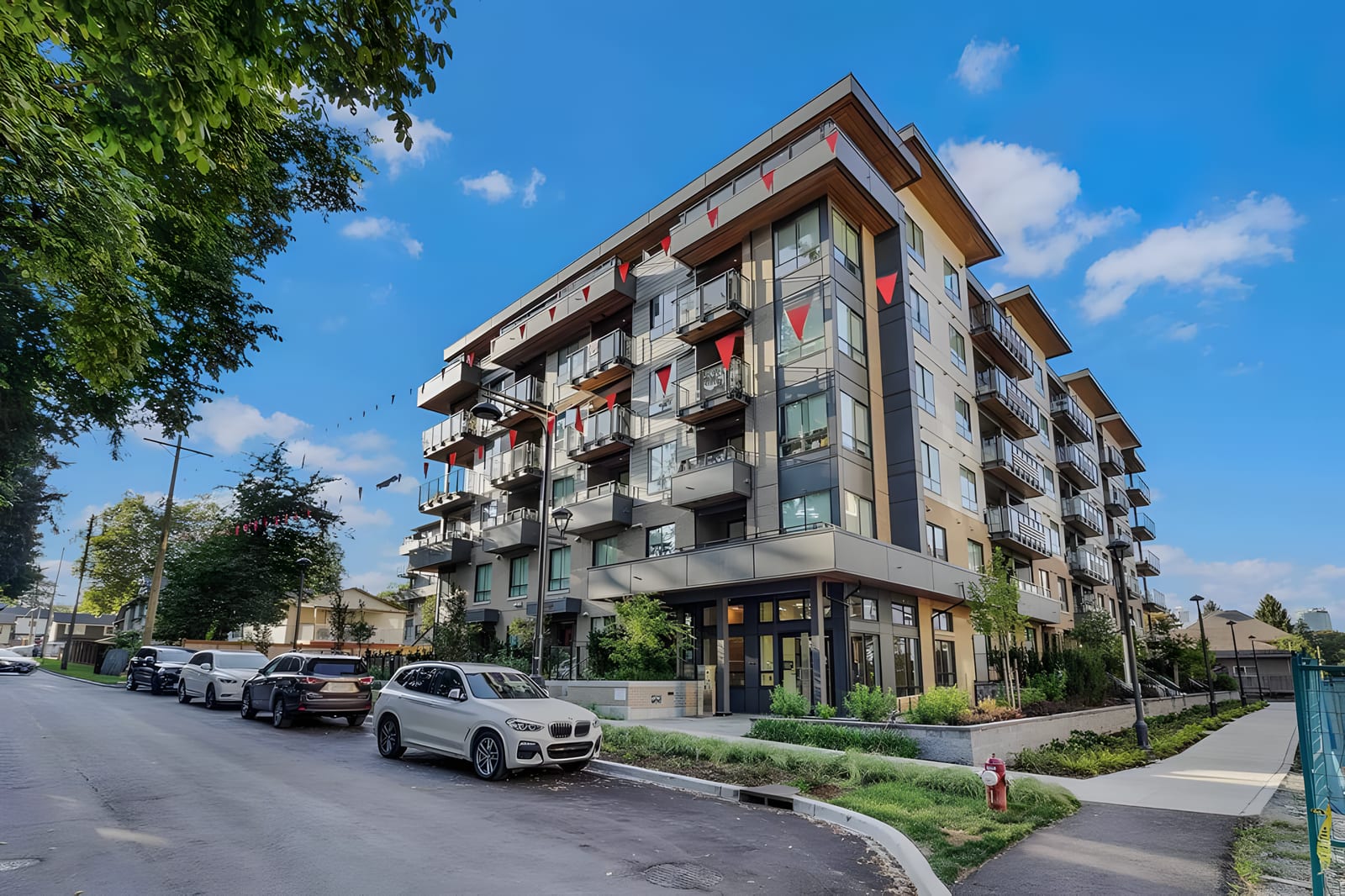 A new 6-storey condo building with launch pennants in Queen Mary Park, Surrey