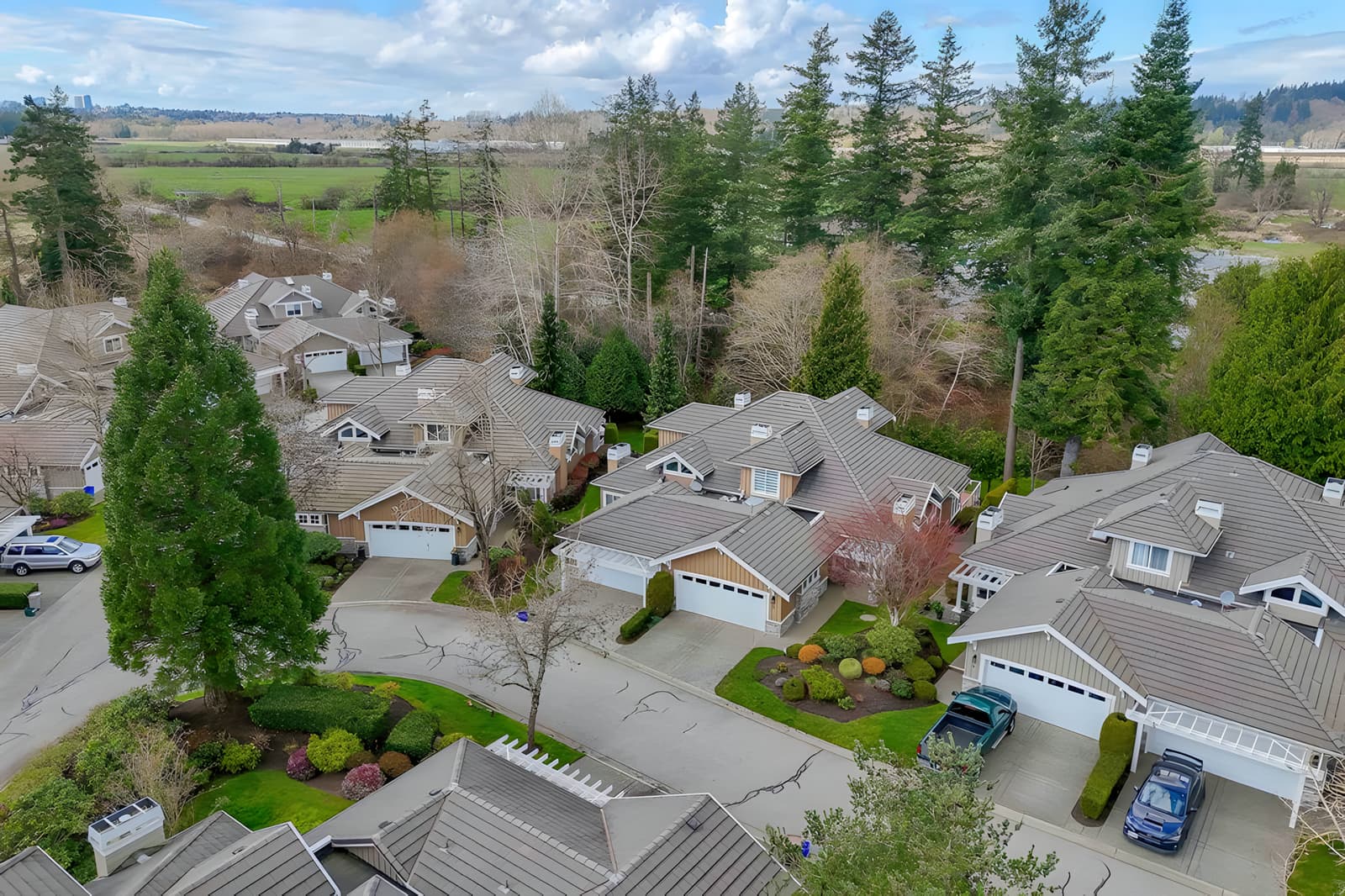 Aerial view of a rancher townhome complex in Hazelmere, South Surrey, with farmland beyond