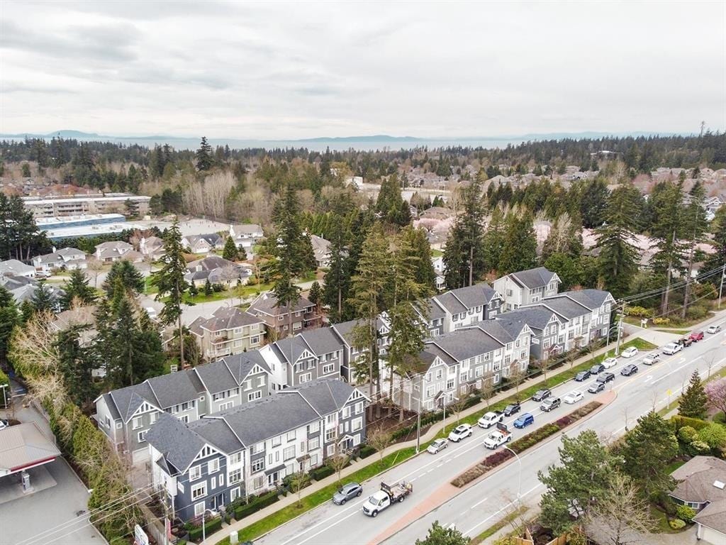 Aerial view of a 3-storey townhome complex along a boulevard in Sunnyside, South Surrey