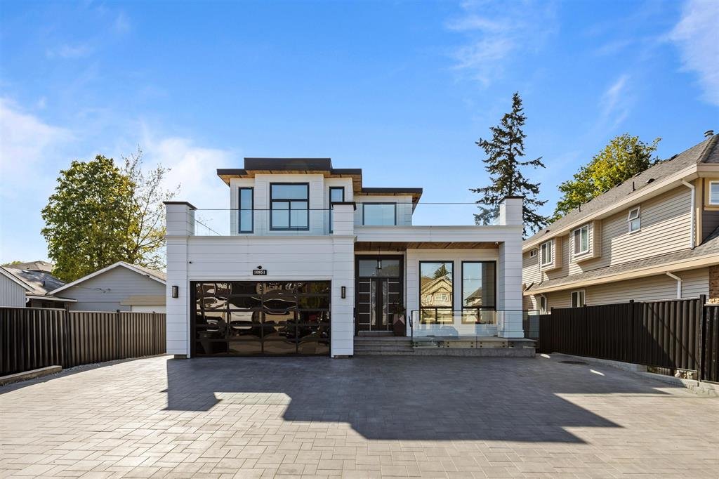 A modern detached home with a paver driveway in Whalley, Surrey