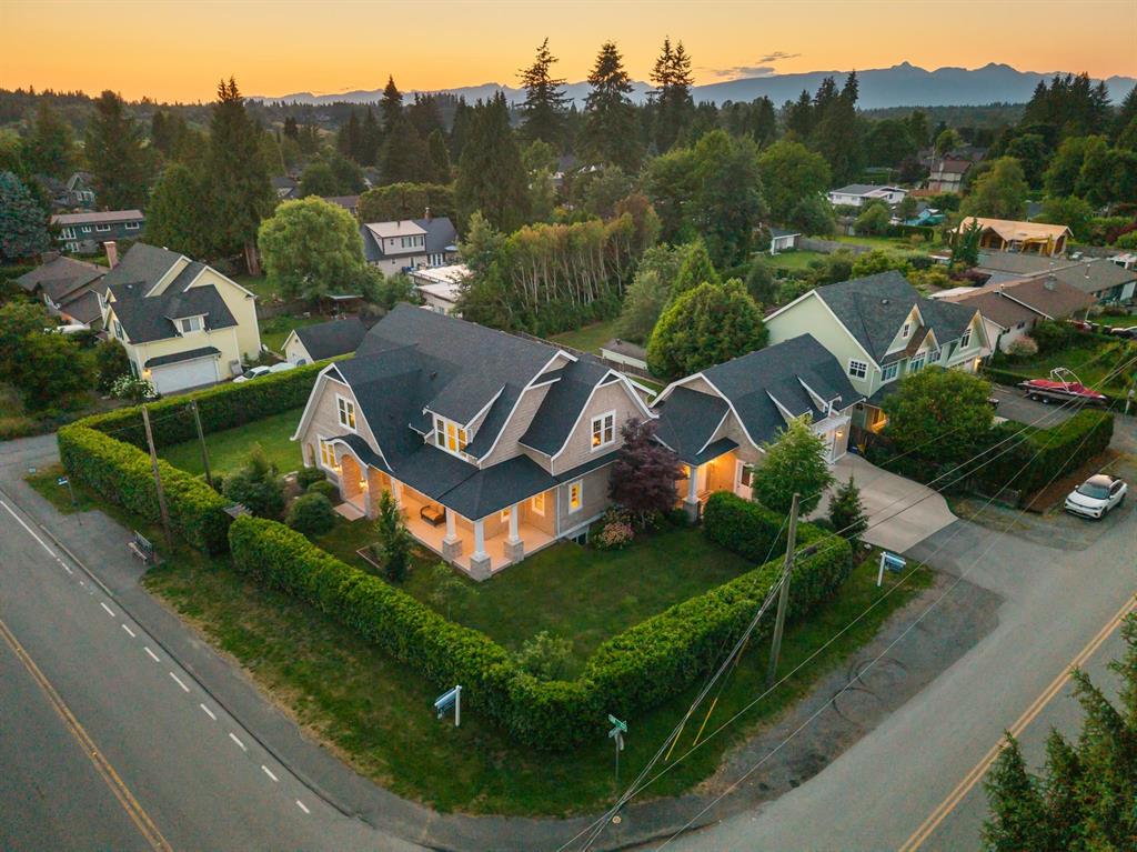 Aerial view of homes in Fort Langley at sunset with the mountains behind