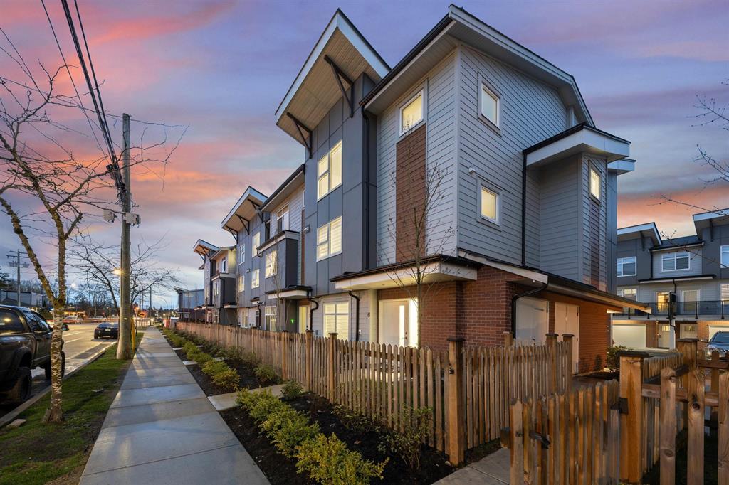 New townhomes along a sidewalk at sunset in Murrayville, Langley
