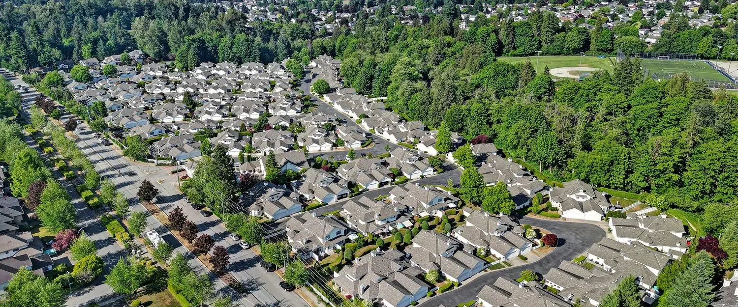 Aerial view of a townhome community among trees in Walnut Grove, Langley