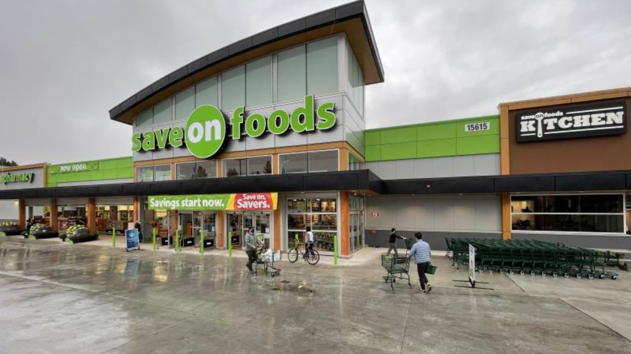 Shoppers with carts outside the Save-On-Foods grocery store in Guildford, Surrey BC