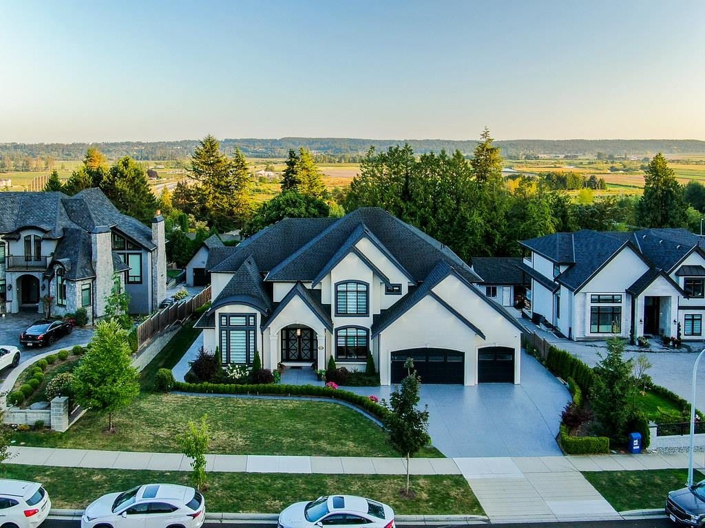 Aerial view of large detached homes in Sullivan, Surrey, with farmland beyond