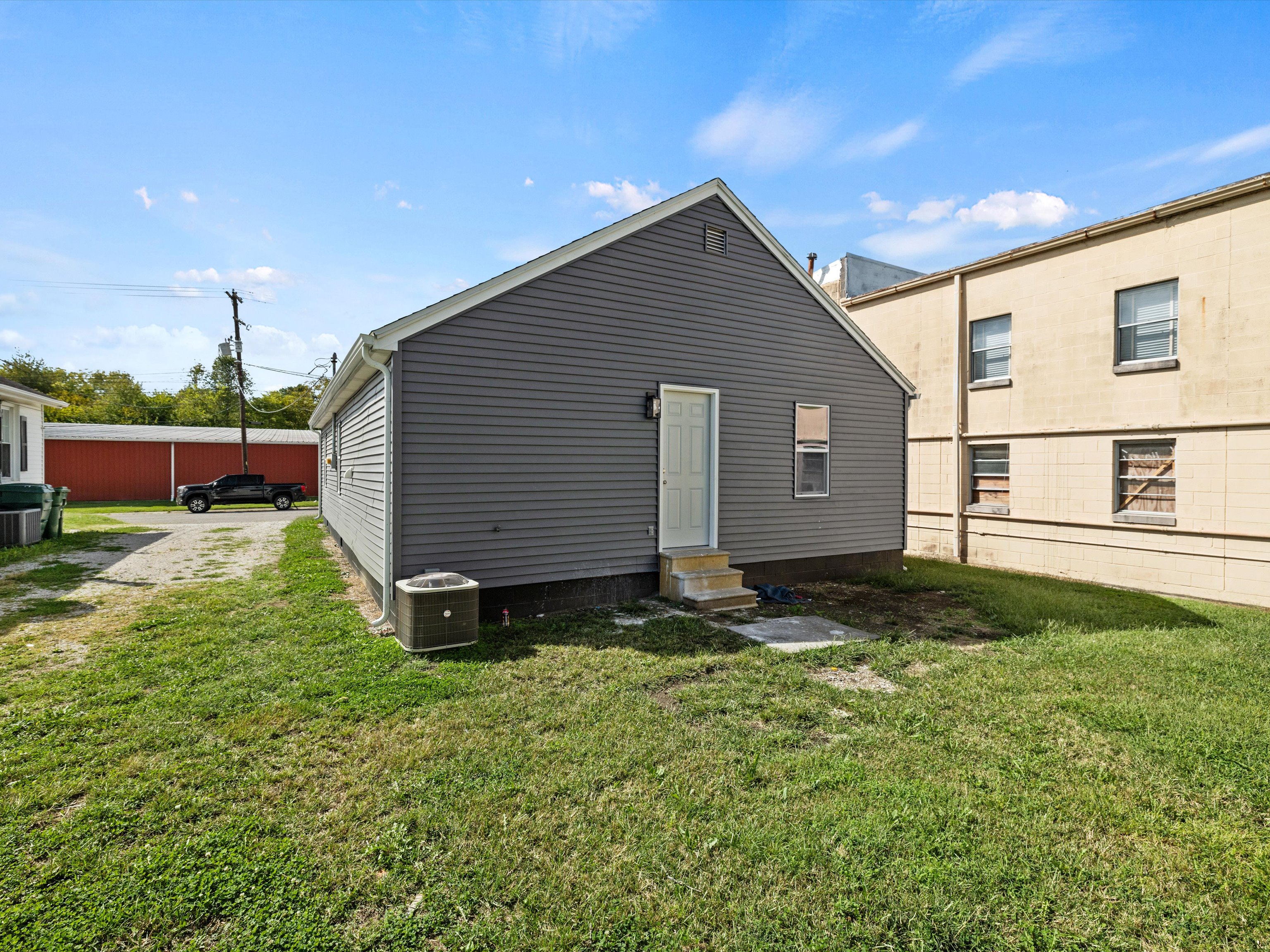 Country homes and open land in Philpot KY showing a quiet rural road and residential properties