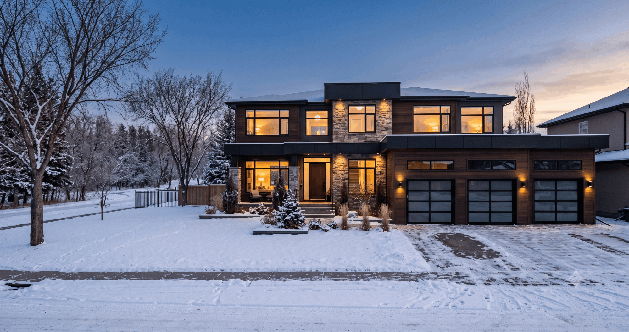 Custom-built Edmonton home with triple garage backing onto a snow-dusted park at dusk, representing what $800,000 buys in Edmonton real estate